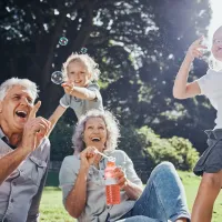 family outside blowing bubbles