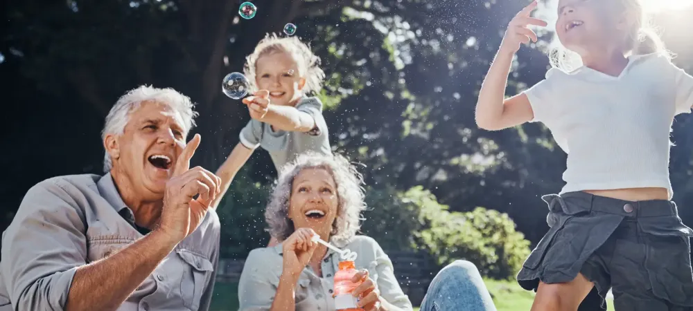 family outside blowing bubbles